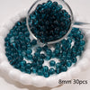 A clear glass jar filled with dark blue round spacer beads for jewelry making