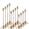 A set of twelve elegant gold-toned metal candle holders with slender stems and flared bases.