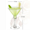 A glass of green cocktail in a martini glass with a lime leaf and a lemon slice, shown with dimension lines.