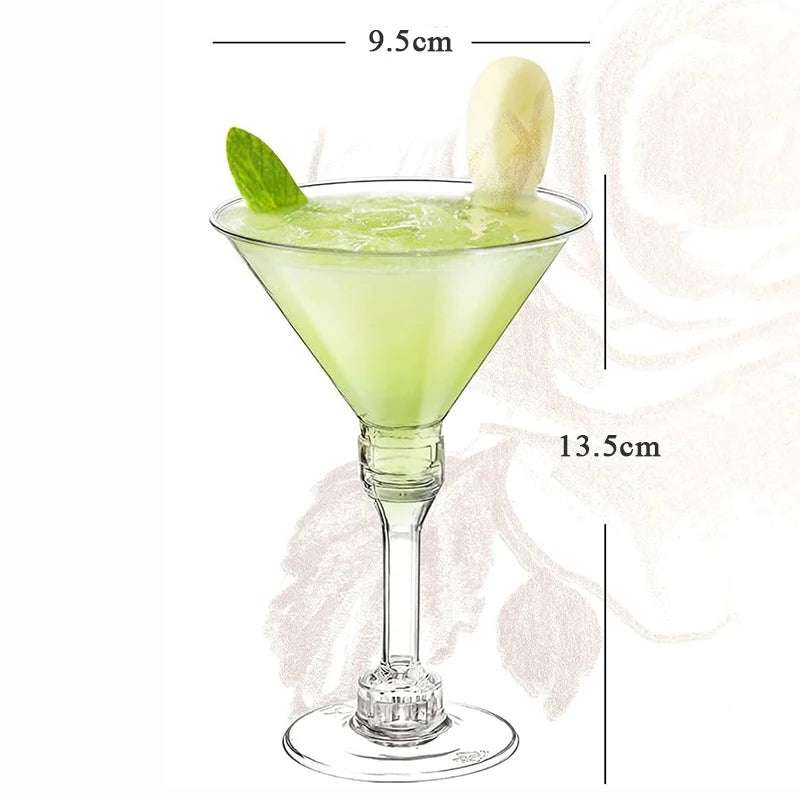 A glass of green cocktail in a martini glass with a lime leaf and a lemon slice, shown with dimension lines.