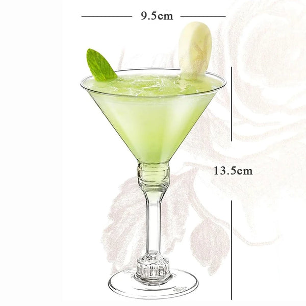 A glass of green cocktail in a martini glass with a lime leaf and a lemon slice, shown next to a dimension scale.