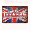 A vintage metal tin sign featuring a red brick background with a distressed Union Jack design and the text Lambrella The Worl
