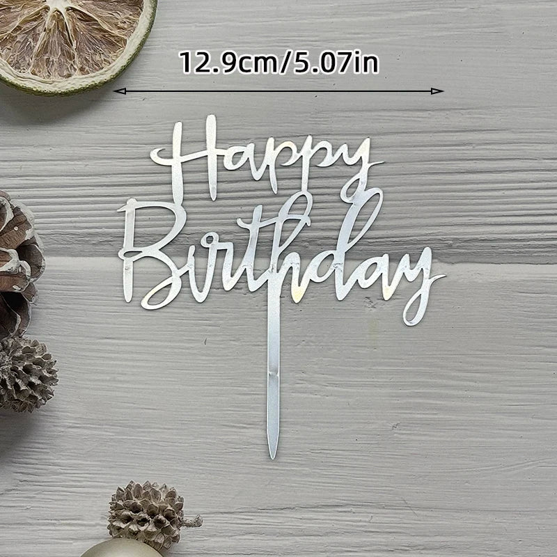 Silver acrylic birthday sign with the words Happy Birthday on a wooden surface