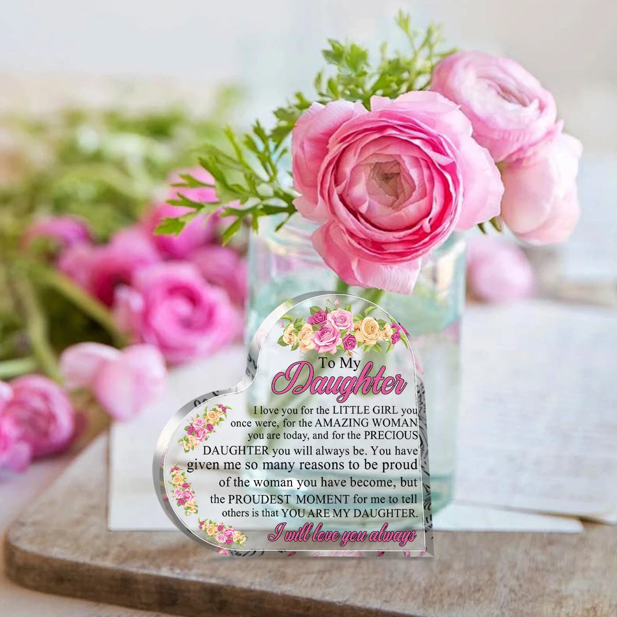 Herzförmige Acrylplatte mit Blumenmotiv und Widmung an eine Tochter, umgeben von rosa Rosen.