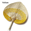 Yellow peach-shaped bamboo woven hand fan with a light beige background