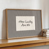 Framed canvas wall art with black vertical stripes and the text How Lucky Are We