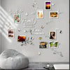 A wall decorated with various photo frames and floral decals featuring the word Family is where life be gins Love Everends