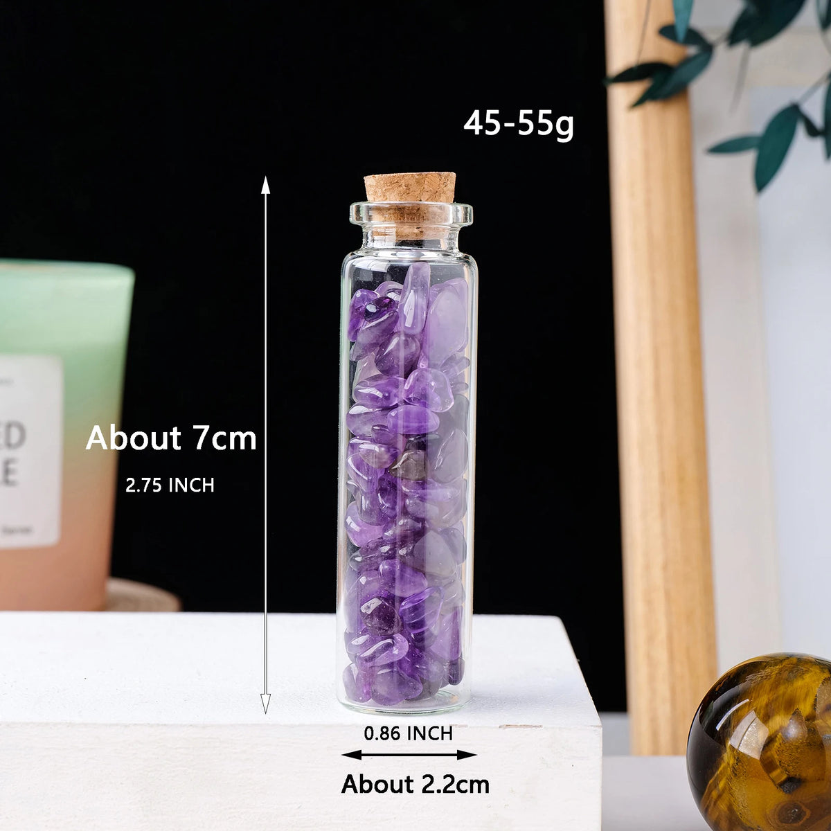 A tall glass bottle filled with purple amethyst crystals, measuring about 7cm and 0.86 inches.