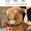A brown West Highland Calf plush toy is being held by a person.