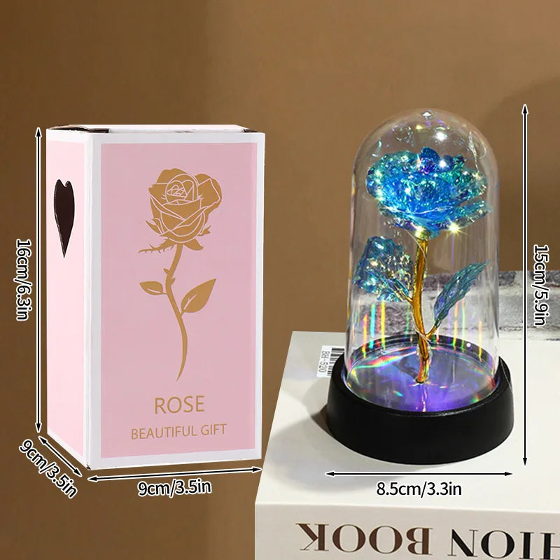 A glass dome featuring an eternal rose, displayed on a white book box.