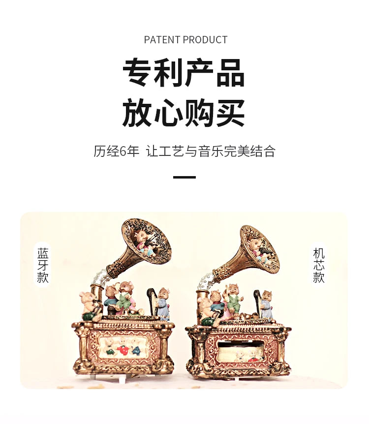 A pair of ornate, antique-style carousel music box decorations featuring small figurines and detailed metalwork.