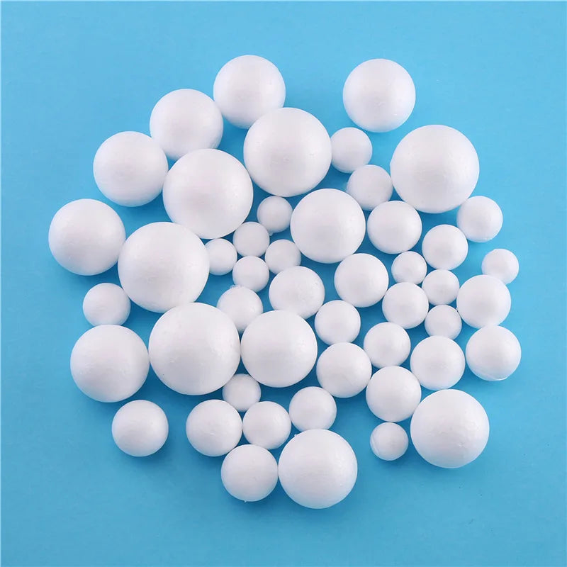 A pile of small white polystyrene foam balls scattered on a light blue surface.