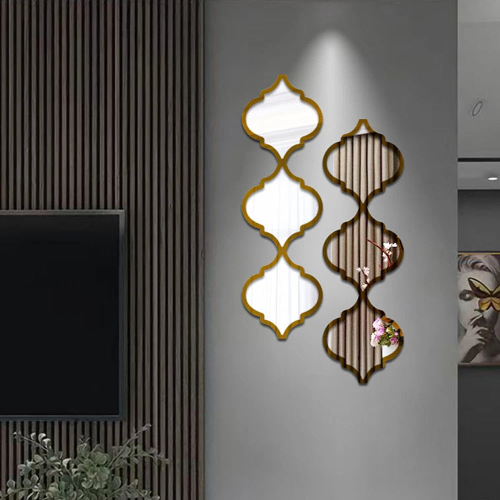 Decorative wall stickers featuring gold-edged, diamond-shaped acrylic mirrors on a gray wall.