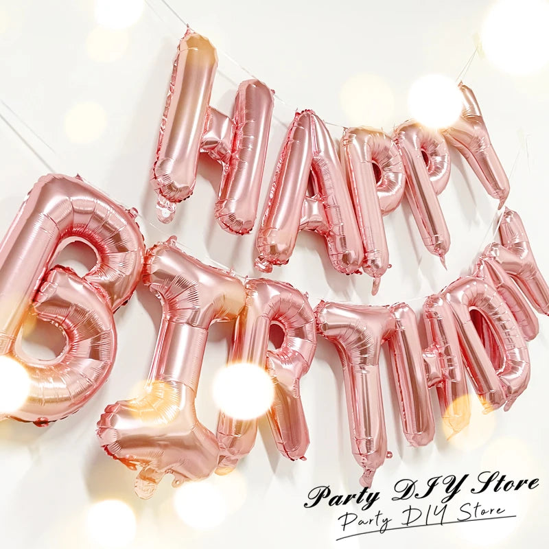 A string of 13 rose gold foil letter balloons spelling out HAPPY for a birthday party decoration set.