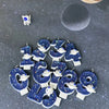 A collection of blue planet-themed birthday candles shaped like numbers 1 through 9, set against a dark gray, starry backgrou