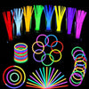 A collection of colorful glow sticks and flexible party bracelets arranged in various colors and shapes.