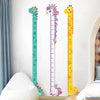 A vertical chart featuring a dinosaur, unicorn, and giraffe to measure height in a child's room.