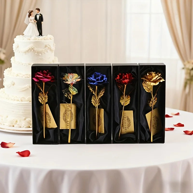 A set of metallic foil rose flowers in various colors displayed in black boxes with cards on a white table.