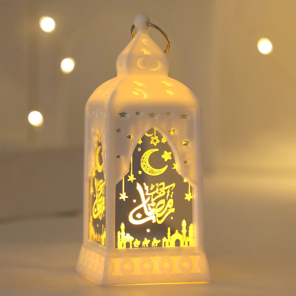 An elegant white LED lantern shaped like a dome with intricate gold calligraphy and stars, illuminated softly.
