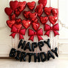 A display of 29 red heart-shaped balloons arranged in a festive cluster.