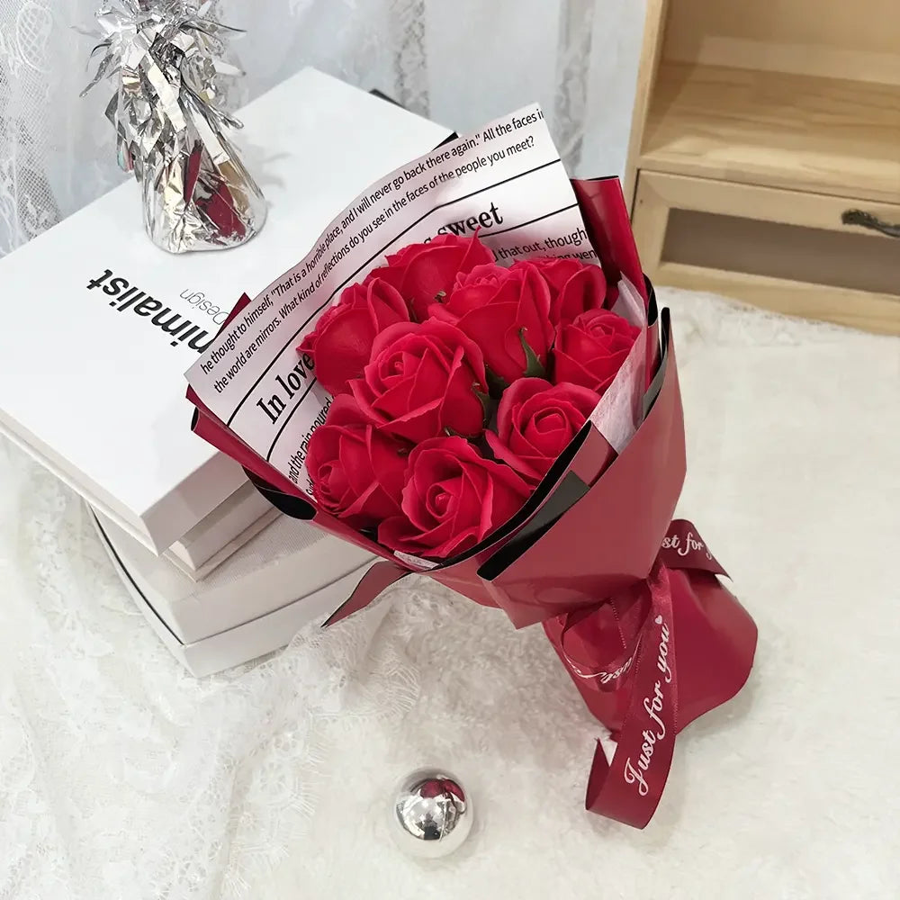 A bouquet of deep red artificial roses wrapped in dark red paper next to a book titled Minimalist.