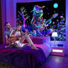A couple posing in a bedroom with a large canvas featuring a psychedelic alien guitar character against a dark background.