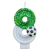 A custom birthday candle shaped like the number 0, covered in green glitter, mounted on a white base.