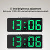 A digital alarm clock displaying 13:06 with a bright green display and a dark gray casing.