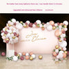 A display of various colored balloons arranged in a floral arch, with the name Elaine written on a pink background.