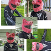 A person wearing a full-face motorcycle helmet covered with a pink cartoon plush helmet cover.
