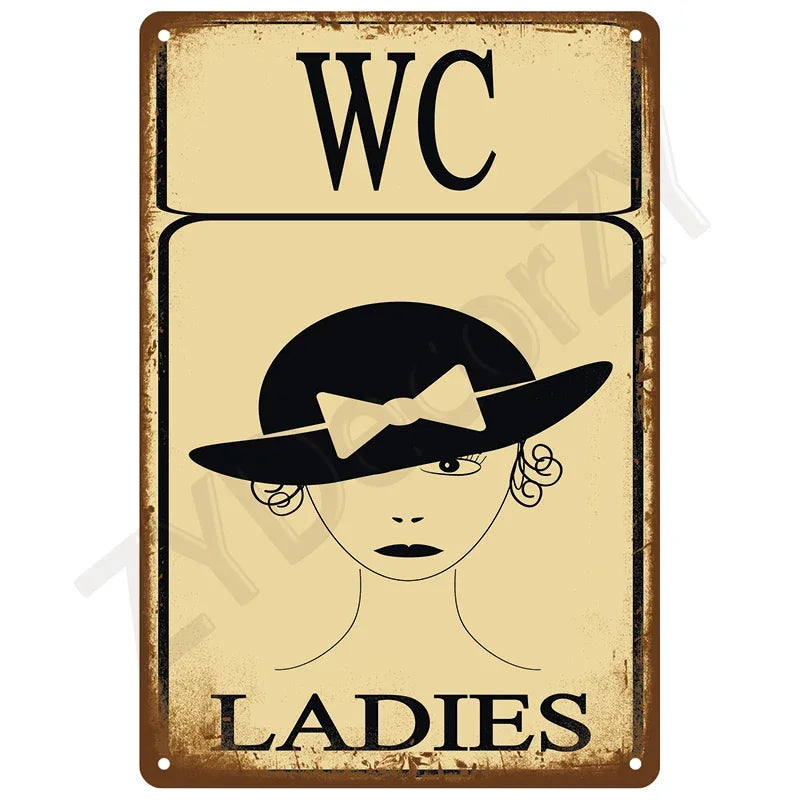 Vintage tin sign with the letters WC and a drawing of a woman labeled LADIES