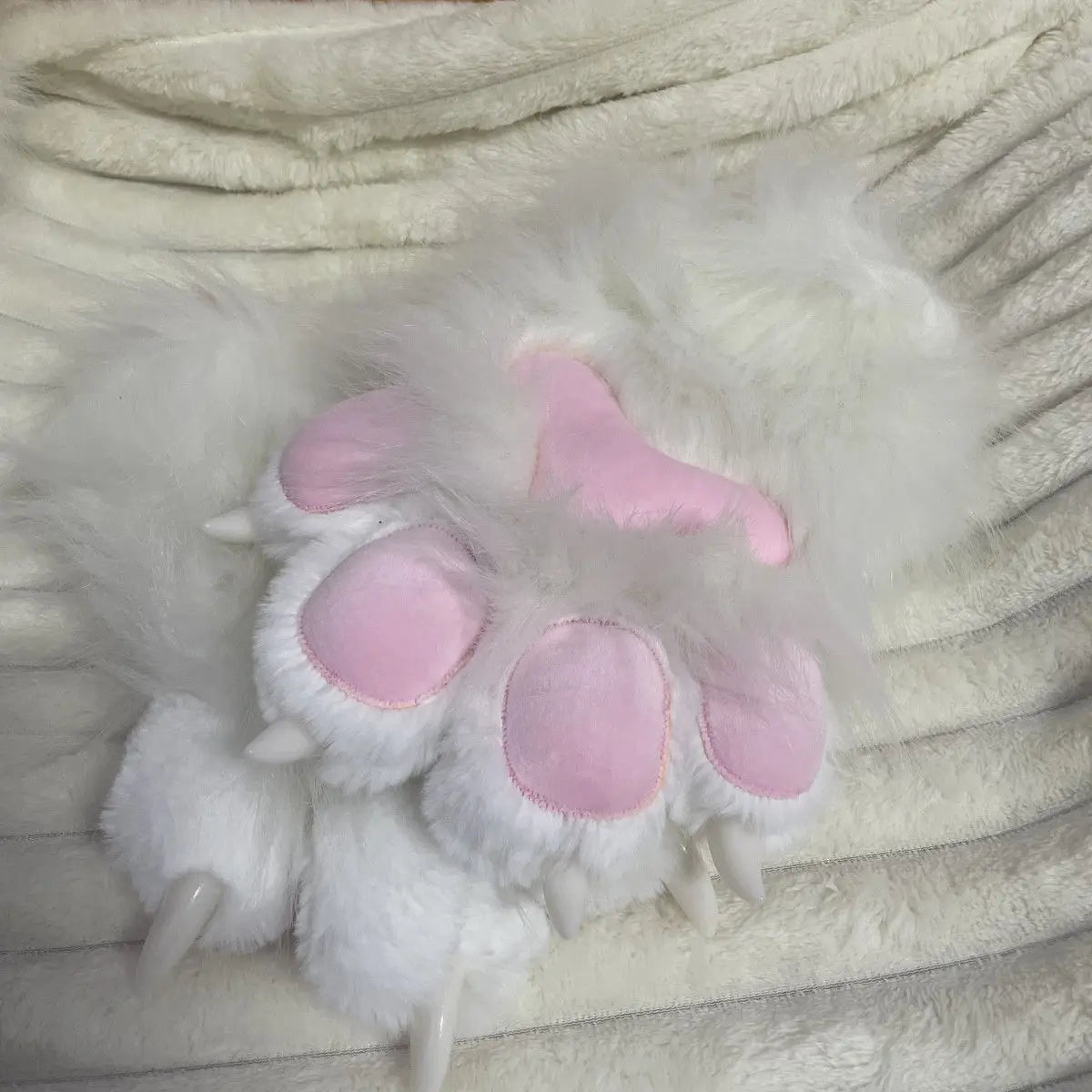 White fluffy cosplay head featuring pink accents and detachable paws