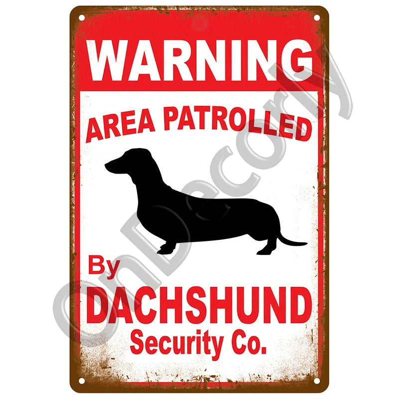 A vintage metal sign with a red background warning area patrolled by a dachshund security company.
