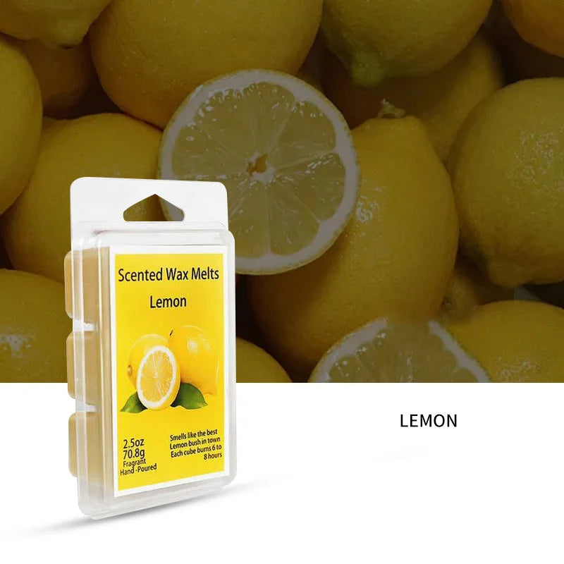 A clear box of lemon scented wax melts with fresh lemon slices and yellow citrus fruits in the background.