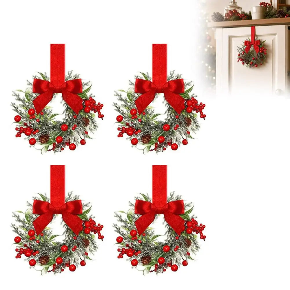 A 10-inch artificial Christmas wreath decorated with green foliage, red berries, and a red velvet bow.