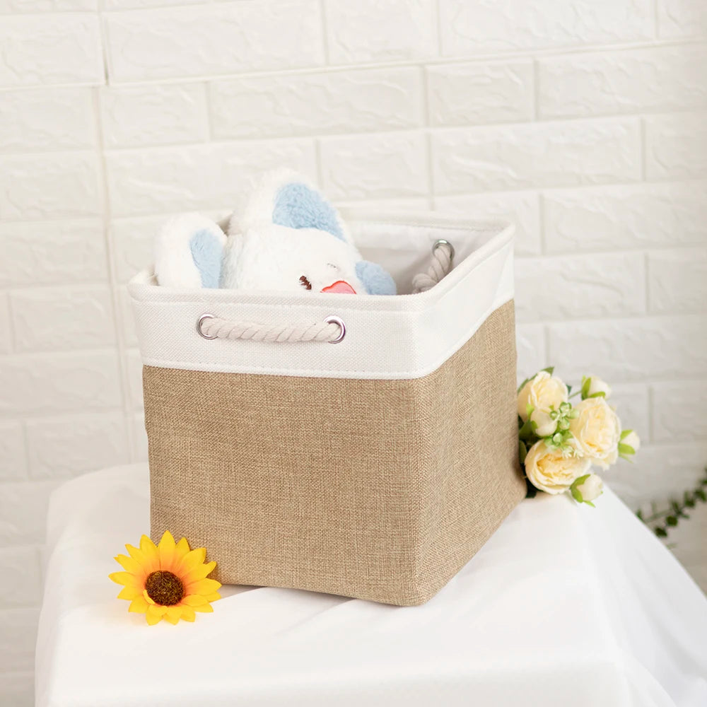 A set of four white fabric storage cubes with metal frames, featuring a light blue bear head.