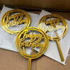 A set of ten gold acrylic happy birthday cake toppers are displayed in a cardboard box.