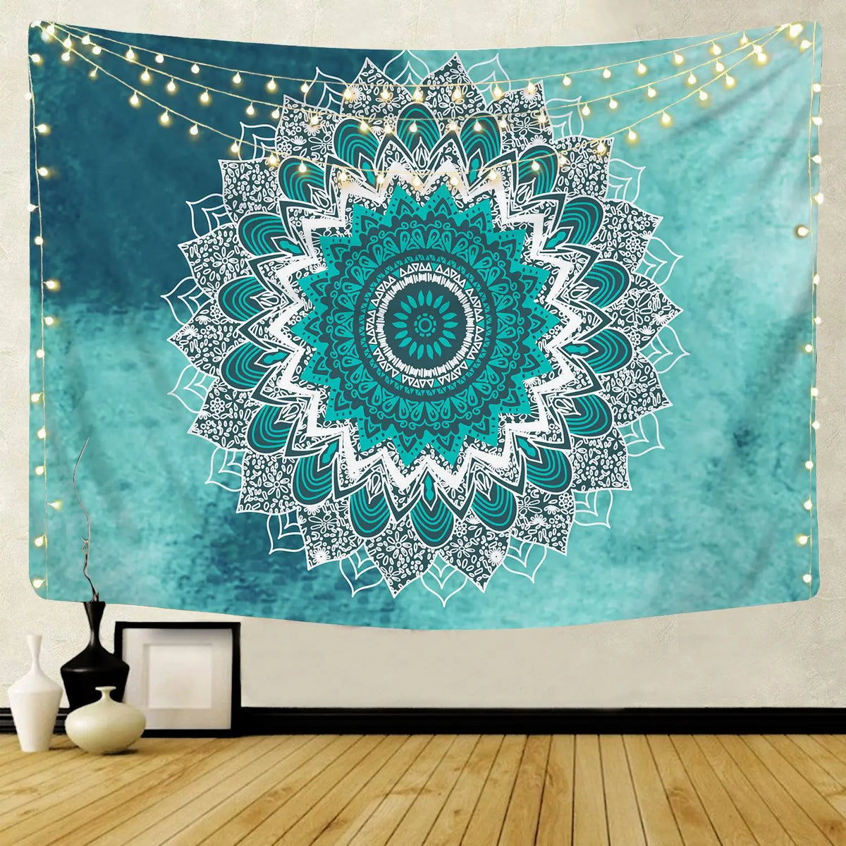 Bohemian mandala tapestry wall art featuring a teal and white floral design with string lights in the background