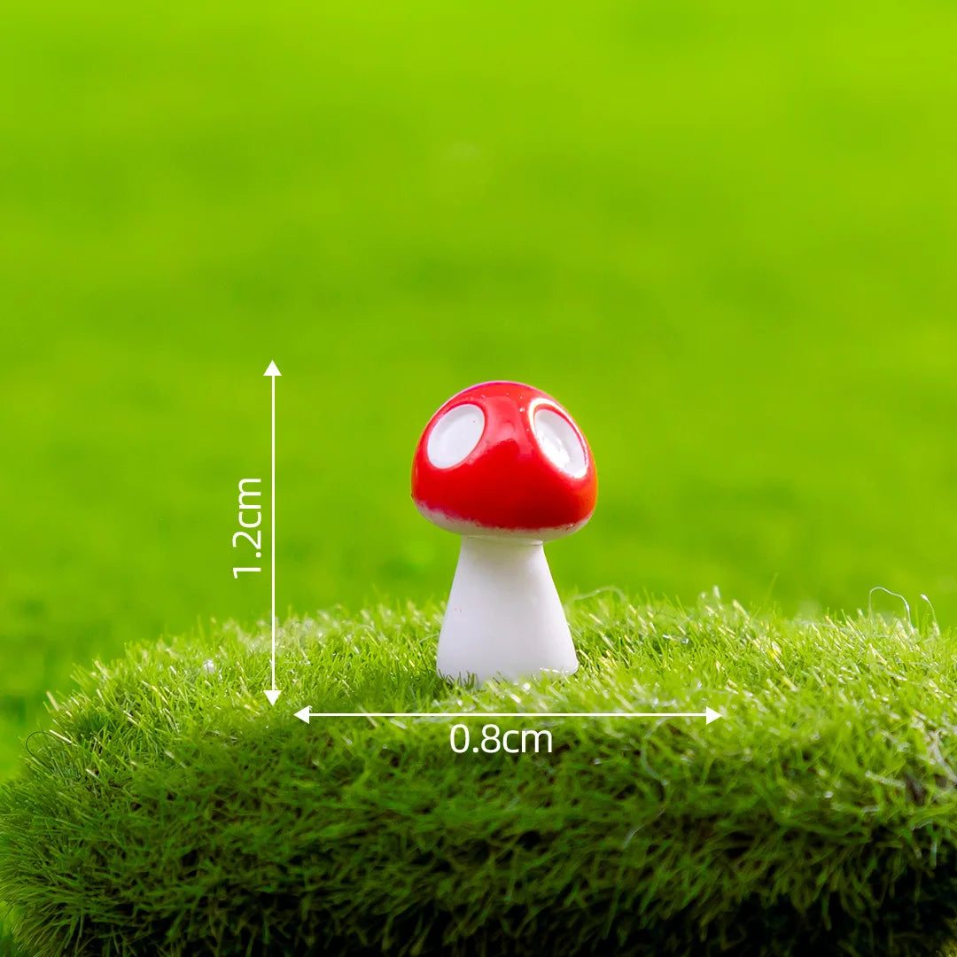 A small red and white resin mini mushroom figurine placed on green grass.