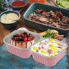 Pink reusable aluminum foil baking cups with lids and spoons containing sliced meats and fruit