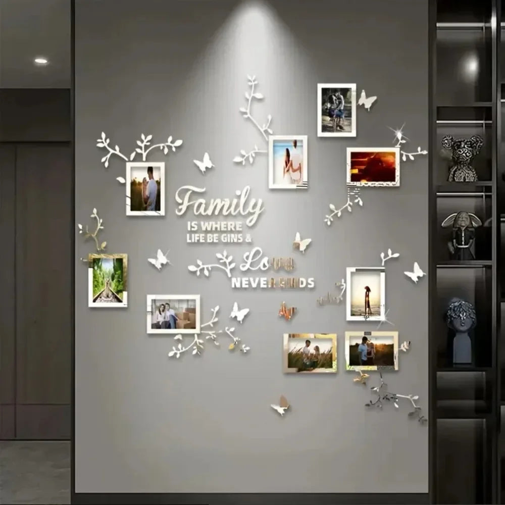 A wall decorated with white acrylic tree branches and photo frames featuring family memories.
