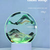 A 3D mobile sand painting table lamp displaying a textured, green and yellow landscape on a circular base.