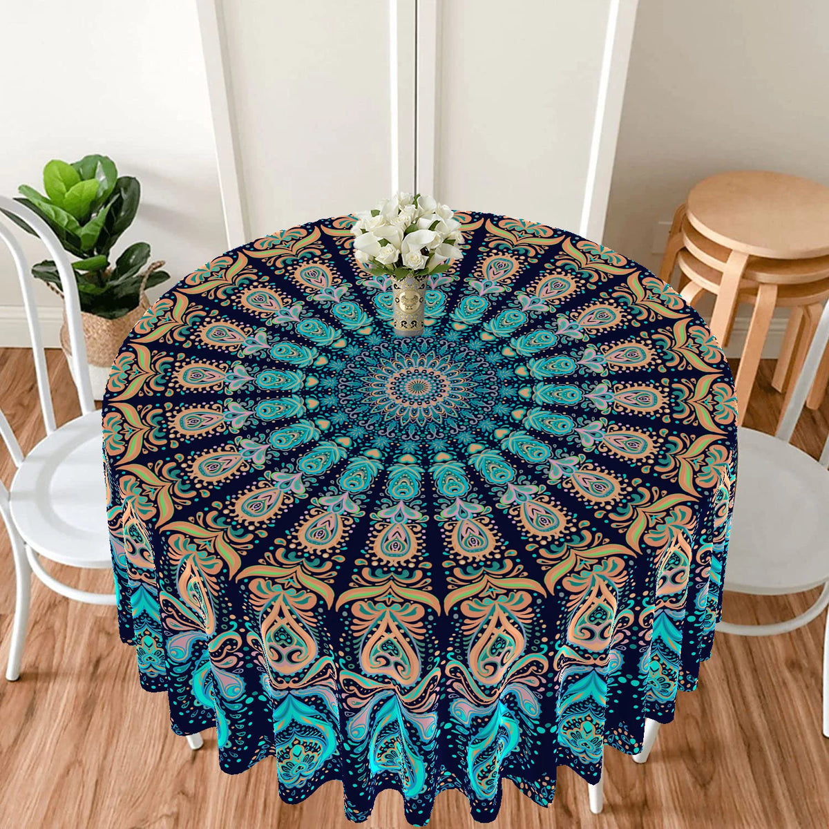 Bohemian peacock mandala round tablecloth featuring blue and teal patterns on a table.