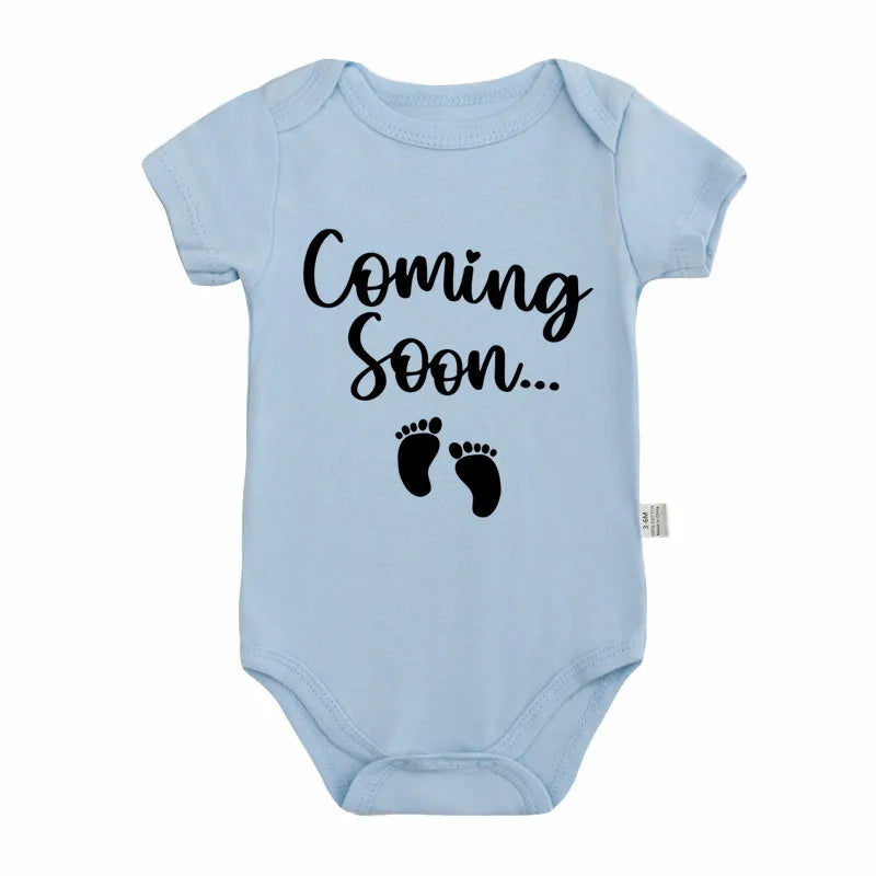 Light blue baby bodysuit with black text that reads Coming Soon