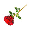 A crystal glass rose flower branch with green leaves and a red rose bloom.