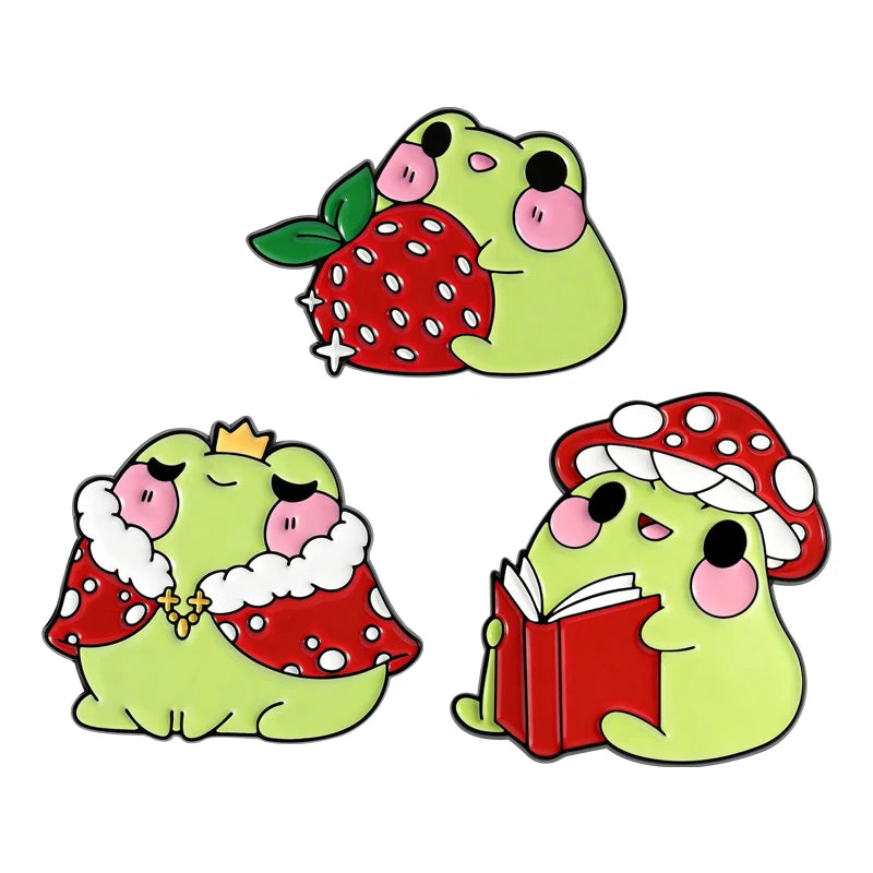 A set of cartoon cat enamel pins featuring designs of a strawberry and a flower.