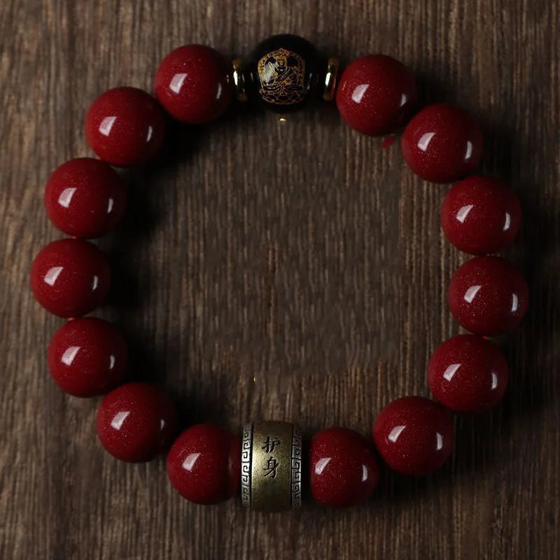 A bracelet made of polished red cinnabar stones with a dark bead closure.