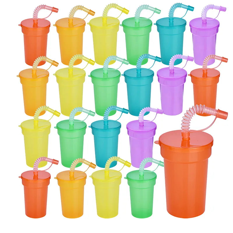 A collection of neon colored reusable sipper cups with spill-proof lids and straws.
