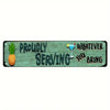 A rustic wooden sign with carved text that reads Proudly Serving Whatever You Bring and features a pineapple and a cocktail g