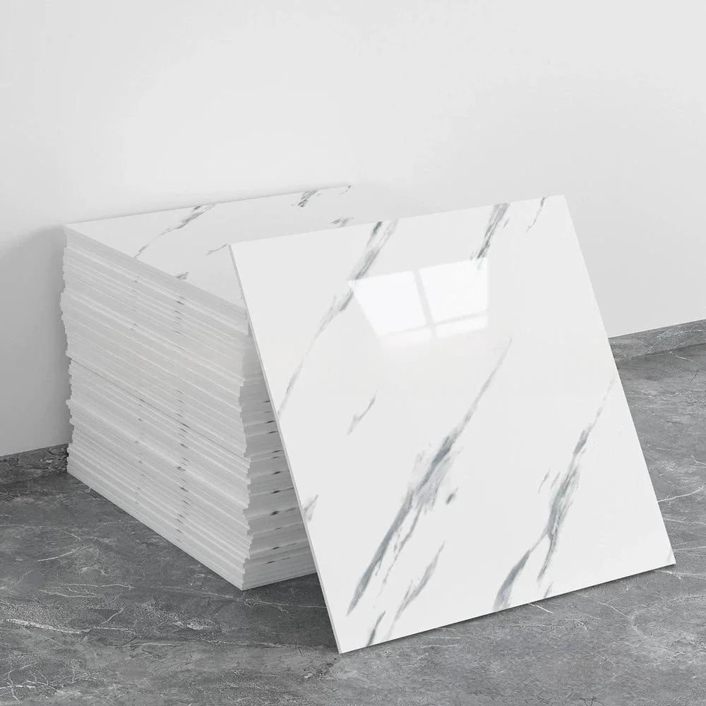 A stack of white marble tile stickers on a gray floor.